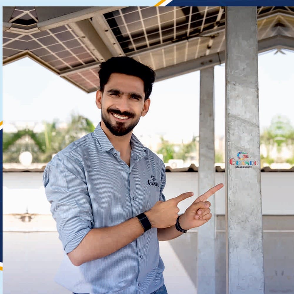 Grando Solar engineer at an elevated carport solar installation